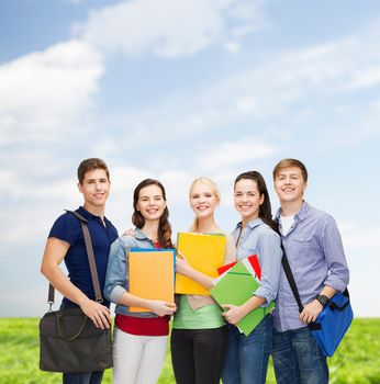 education and people concept - group of smiling students standing