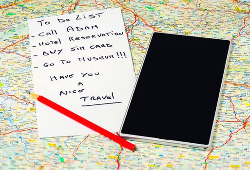 In the pictured a map, a pencil , a phone / tablet and a list of things to do .