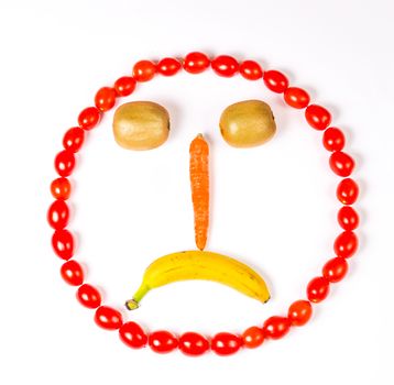 This sad smiley is made wirh carrot,kiwi,cherry tomatoes and banana