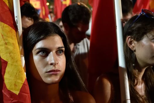 GREECE, Athens: A supporter of the Communist Party of Greece (KKE) looks on during the party's campaign rally in Athens on September 16, 2015, ahead of the forthcoming snap elections on September 20. At the rally, KKE General Secretary Dimitris Koutsoumpas addressed supporters.