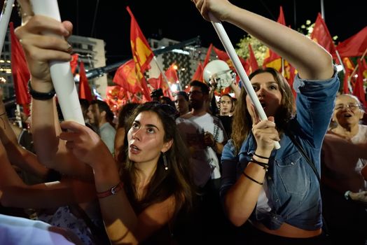 GREECE, Athens: Women cheer as the Communist Party of Greece (KKE) holds a campaign rally in Athens on September 16, 2015, ahead of the forthcoming snap elections on September 20. At the rally, KKE General Secretary Dimitris Koutsoumpas addressed supporters.