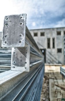 Steel girders in outdoor warehouse.