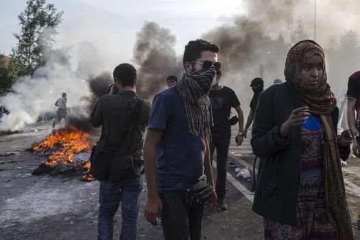 SERBIA, Horgos: Fires rage as Hungarian police fire tear gas and water cannons into the refugees in the Serbian border town of Horgos on September 16, 2015, after Hungary closed its border in an effort to stem the wave of refugees entering the country. 