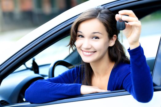 Cute girl shows a car key