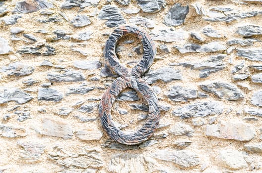 Old castle stone wall with speed Nr. 8 in wrought iron. texture background