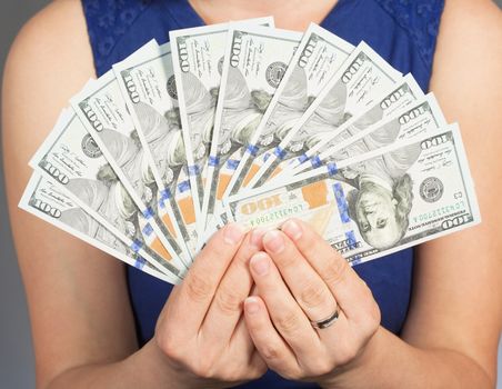 Woman in Blue Dress Holding New 100 US Dollar Bills