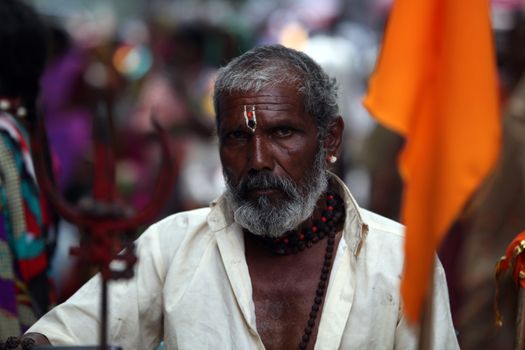 An Indian pilgrim carrying the trishul, who is a devotee of Lord Shiva.
