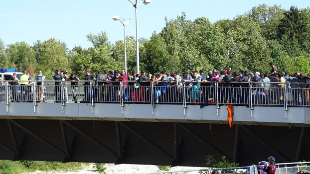 GERMANY, Freilassing: Refugees wait at the bridge on Austrai/Germany border, in Freilassing, Bavaria, on the German side of the Germany-Austria border, September 17, 2015.