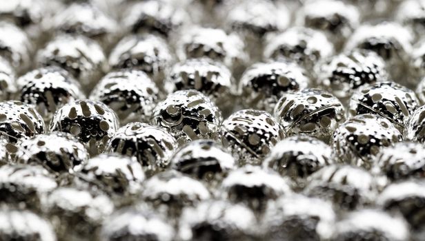 Beautiful metal beads closeup on white background