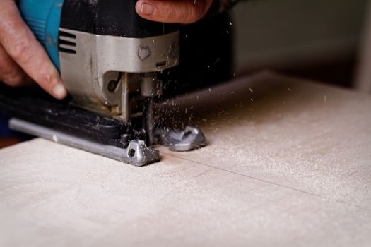 Photo of a man working with fret saw