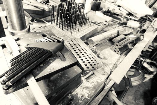 Set of tools over a wood panel on black and white