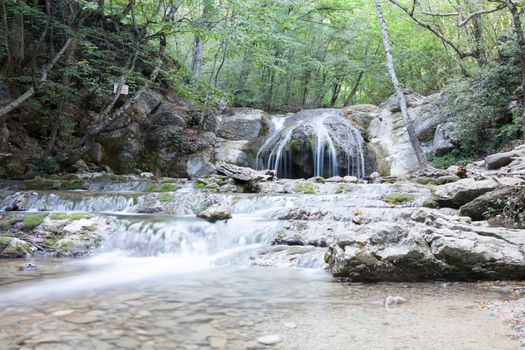 beautiful forest falls in mountains in the summer afternoon, the Crimea, Russia