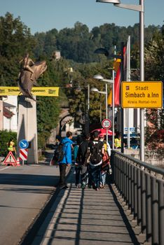 GERMANY, Simbach am Inn: Refugees walk on a bridge and cross the border from Austria to Germany in order to join Simbach am Inn, in south-eastern Germany on September 17, 2015.  