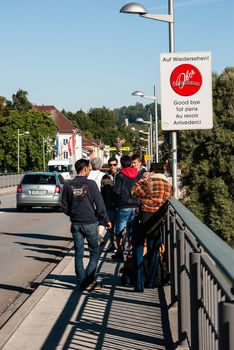 GERMANY, Simbach am Inn: Refugees walk on a bridge and cross the border from Austria to Germany in order to join Simbach am Inn, in south-eastern Germany on September 17, 2015.  