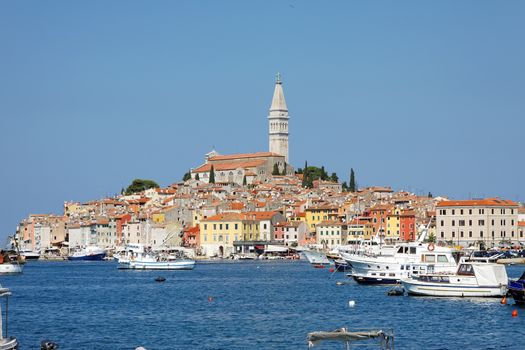ROVINJ, CROATIA - SEPTEMBER 12 : Boats and ships in the marina with the old town buildings in the background on September 12, 2015 in Rovinj, Croatia. Rovinj is a popular tourist destination on the Adriatic coast.