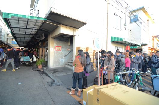 Tokyo, Japan - November 26, 2013: Tsukiji market is a large market for fish in central Tokyo. The market consists of small shops and restaurants crowded along narrow lanes. Tokyo, Japan.