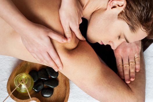 Man enjoying a wellness back massage in a spa