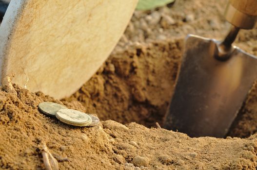 Old coins found while metal detecting. Metal detector coil and spade. Sports and hobbies