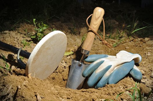 Night metal detecting. Metal detector coil, spade and gloves. Sports and hobbies