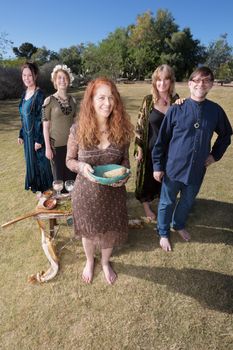 Group of modern witches smiling with altar and smudge stick