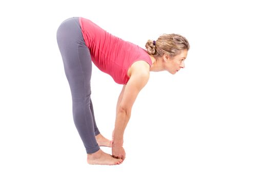 Young woman making a yoga posture on a white background