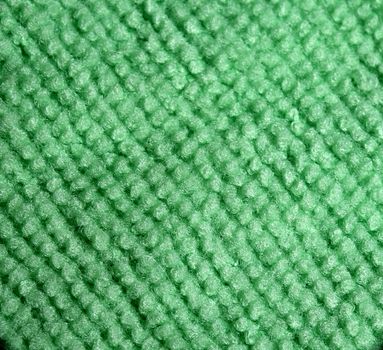 Close up of a green microfiber cloth. Textile texture background