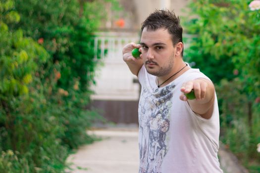 Young man pretending to be a ninja ready to throw....lemons!