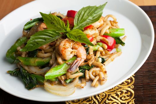 Thai food shrimp stir fry with lo mein noodles Shallow depth of field.