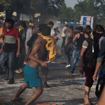 SERBIA, Horgos: Running battles take place as Hungarian riot police clash with refugees waiting to cross the border from the Serbian border town of Horgos on September 16, 2015. 