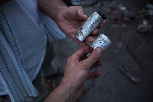 SERBIA, Horgos: Tear gas cannisters are held by protesters as Hungarian riot police clash with refugees waiting to cross the border from the Serbian border town of Horgos on September 16, 2015. 