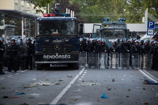 SERBIA, Horgos: Hungarian riot police line the street as they clashed with refugees waiting to cross the border from the Serbian border town of Horgos on September 16, 2015. 