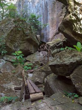 Footpath in valley among cliff on rainforest