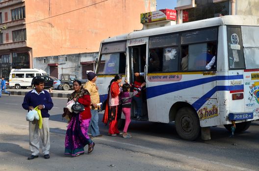 Jaipur, India - December 30, 2014: Indian people taking a bus in Jaipur, Rajasthan, India on December 29, 2014 . Jaipur is the capital and largest city of the Indian state of Rajasthan in Northern India