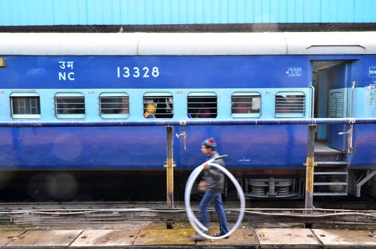 Jaipur, India - January 3, 2015: passengers at the window of a Indian Railway train at the railway station of Jaipur, Rajasthan, India. Indian Railways carries about 7,500 million passengers annually.