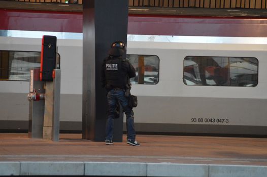 NETHERLANDS, Rotterdam: Members of a special unit of Dutch police stand guard near a Thalys train on a platform of Rotterdam central station, on September 18, 2015, as a man has locked himself in the train'sbathroom. The Thalys plus several platforms have been evicted.