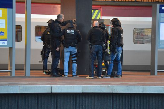 NETHERLANDS, Rotterdam: Members of a special unit of Dutch police stand guard near a Thalys train on a platform of Rotterdam central station, on September 18, 2015, as a man has locked himself in the train'sbathroom. The Thalys plus several platforms have been evicted.