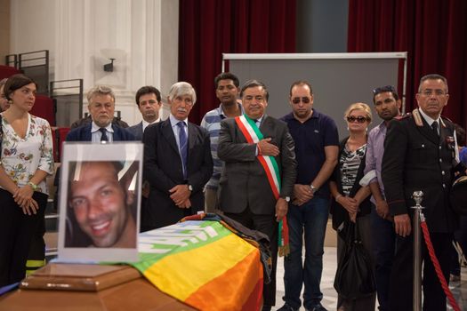 ITALY, Palermo: People look over coffin	The funeral of Giovanni Lo Porto was held on September 18, 2015, with Mayor Leoluca�Orlando declaring a day of mourning in the city.  	Lo Porto, an aid worker, was being held captive by al-Qaida along with American Warren Weinstein.  	The pair were mistakenly killed during a U.S. drone strike in January. 