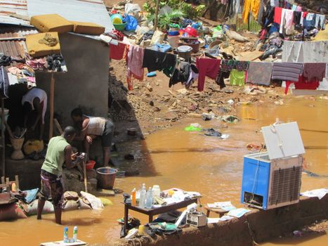 SIERRA LEONE, Freetown: Severe flooding that hit Freetown, Sierra Leone this week has left four people dead and is posing a serious risk of Ebola spreading. Residents at Congo Cross Bridge worked to dry out their homes and contain the spread of the disease on September 17, 2015. 