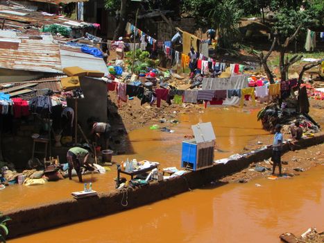 SIERRA LEONE, Freetown: Severe flooding that hit Freetown, Sierra Leone this week has left four people dead and is posing a serious risk of Ebola spreading. Residents at Congo Cross Bridge worked to dry out their homes and contain the spread of the disease on September 17, 2015. 