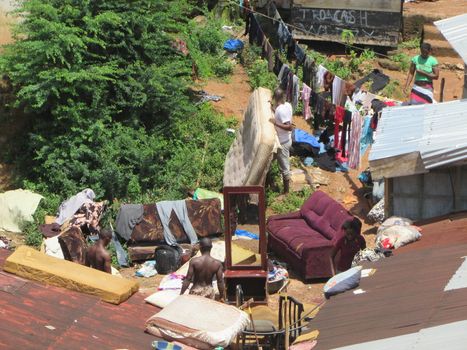 SIERRA LEONE, Freetown: Severe flooding that hit Freetown, Sierra Leone this week has left four people dead and is posing a serious risk of Ebola spreading. Residents at Congo Cross Bridge worked to dry out their homes and contain the spread of the disease on September 17, 2015. 