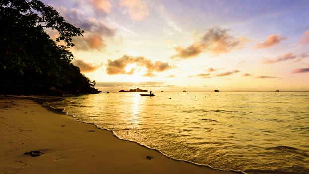 Beautiful landscapes of golden light the sky over the beach and sea during sunrise on Koh Miang Islands, Mu Ko Similan National Park, Phang Nga, Thailand, 16:9 widescreen