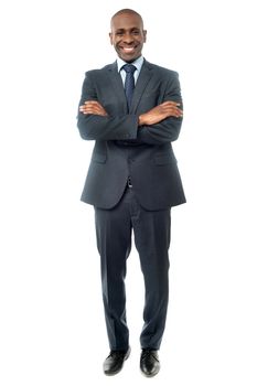 Full length image of smiling businessman standing