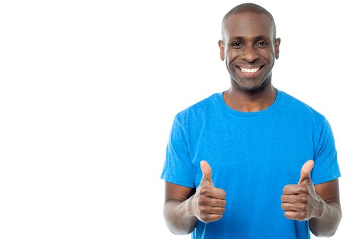 Smiling man showing double thumbs up to the camera