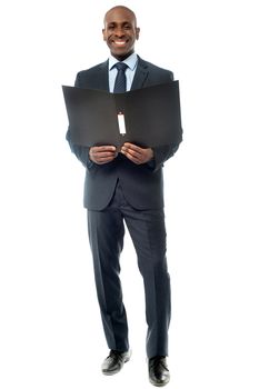 Full length of businessman posing  with folder