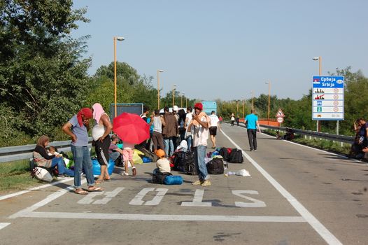 SERBIA, Border with Croatia: Refugees camp out at the Serbian-Croatian border on September 18, 2015 after Croatia decided to shut their border with Serbia.This decision was made after more than 11,000 refugees entered Croatia in a single day. Refugees had to spend entire night and half of the next day at the border. Local authorities in Serbia have organized bus transportation to take the refugees from the border to the reception camps.