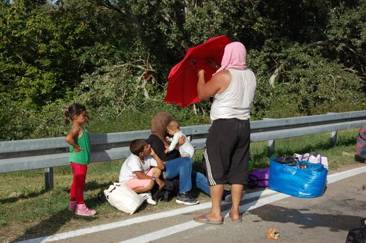 SERBIA, Border with Croatia: Refugees camp out at the Serbian-Croatian border on September 18, 2015 after Croatia decided to shut their border with Serbia.This decision was made after more than 11,000 refugees entered Croatia in a single day. Refugees had to spend entire night and half of the next day at the border. Local authorities in Serbia have organized bus transportation to take the refugees from the border to the reception camps.
