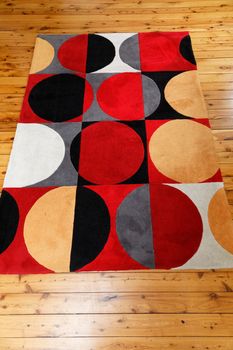 A rug with colourful circular patterns