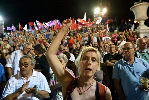 GREECE, Athens: A supporter of the Syriza party pumps her fist during the party's main election campaign rally in Athens, Greece on September 18, 2015. The Greek General Election will be held on September 20
