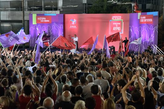 GREECE, Athens: Supporters of the Syriza party wave flags while leader Alexis Tsipras speaks during the party's main election campaign rally in Athens, Greece on September 18, 2015. The Greek General Election will be held on September 20