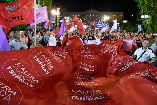 GREECE, Athens: Supporters of the Syriza party wave a large red party banner during the party's main election campaign rally in Athens, Greece on September 18, 2015. The Greek General Election will be held on September 20